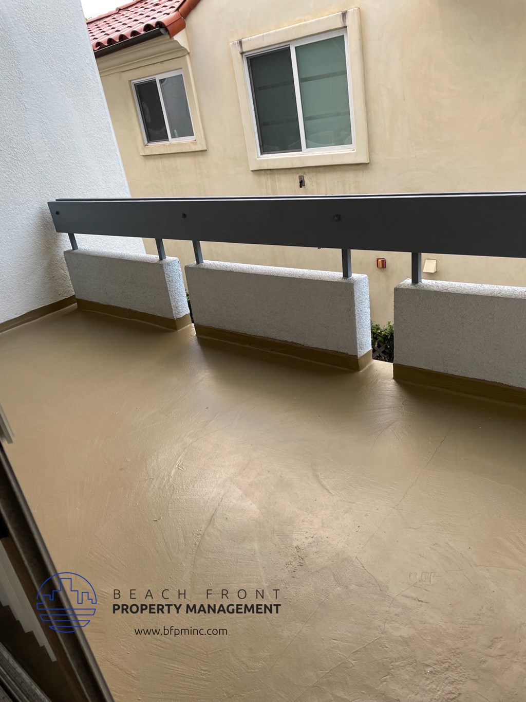a balcony with a bench and a table on it